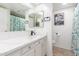 The bathroom features a white vanity with an undermount sink, a mirror, and a shower with a floral curtain at 520 E Jahns Pl, Casa Grande, AZ 85122