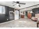 This is a spacious bonus room featuring ceramic floors, a ceiling fan, and an exterior door at 520 E Jahns Pl, Casa Grande, AZ 85122