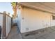 Exterior view highlighting a covered patio area with storage, showcasing the home's outdoor functionality and clean architectural lines at 520 E Jahns Pl, Casa Grande, AZ 85122