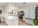 Modern kitchen featuring white cabinets, stainless steel appliances, and an island with countertop seating at 520 E Jahns Pl, Casa Grande, AZ 85122