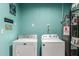 Functional laundry room featuring a washer, dryer, and water heater at 520 E Jahns Pl, Casa Grande, AZ 85122