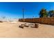 Backyard with a fire pit area, gravel, and wooden fence at 545 N 98Th St, Mesa, AZ 85207
