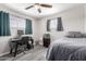 Bedroom with a bed, desk, and gray wood-look flooring at 545 N 98Th St, Mesa, AZ 85207