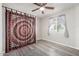 Bedroom with ceiling fan, window, and gray wood-look flooring at 545 N 98Th St, Mesa, AZ 85207