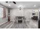 Dining room with a modern light fixture, seating for four, and gray wood-look flooring at 545 N 98Th St, Mesa, AZ 85207