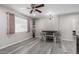 Dining room with a modern light fixture, seating for four, and gray wood-look flooring at 545 N 98Th St, Mesa, AZ 85207