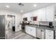Bright kitchen with white cabinets, stainless steel appliances, and gray countertops at 545 N 98Th St, Mesa, AZ 85207