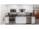 Bright kitchen with white cabinets, stainless steel appliances, and gray countertops at 545 N 98Th St, Mesa, AZ 85207