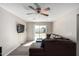 Inviting living room with ceiling fan, stylish sofa, and sliding door access at 545 N 98Th St, Mesa, AZ 85207