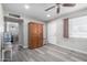Bright living room with gray laminate flooring and a ceiling fan at 545 N 98Th St, Mesa, AZ 85207