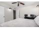 Main bedroom featuring two sconces, a ceiling fan and neutral walls at 545 N 98Th St, Mesa, AZ 85207
