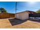Backyard shed with access door, surrounded by wood fence and gravel at 545 N 98Th St, Mesa, AZ 85207