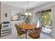 The dining area includes a wood table, 4 chairs, a ceiling fan, and access to the patio at 5525 E Thomas Rd # O8, Phoenix, AZ 85018
