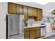 Spacious kitchen featuring stainless steel appliances, white countertops, and wood cabinets with breakfast nook at 5525 E Thomas Rd # O8, Phoenix, AZ 85018
