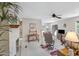 Bright living room featuring fireplace, ceiling fan, and access to dining area with natural light from sliding glass door at 5525 E Thomas Rd # O8, Phoenix, AZ 85018