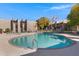 Outdoor pool with seating and lush landscaping, set against a backdrop of well-maintained community buildings on a sunny day at 5525 E Thomas Rd # O8, Phoenix, AZ 85018