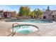 Relaxing community hot tub with pool and seating, nestled amongst green trees and well-maintained landscaping at 5525 E Thomas Rd # O8, Phoenix, AZ 85018