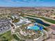 Stunning aerial view of community pool, clubhouse, and golf course with lush landscaping at 5652 W Cinder Brook Way, Florence, AZ 85132