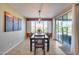 Dining area with a view, decorative lighting, slider to the backyard, seating for six, and colorful art at 5652 W Cinder Brook Way, Florence, AZ 85132