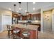 Modern kitchen featuring a granite countertop island with a stainless steel refrigerator at 5652 W Cinder Brook Way, Florence, AZ 85132