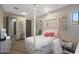 Bright bedroom featuring a four-poster bed, desk area, and stylish decor at 5725 S Topaz Pl, Chandler, AZ 85249