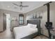 Bedroom featuring a tufted headboard, cactus art, and exercise equipment at 5725 S Topaz Pl, Chandler, AZ 85249