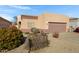 Exterior view of home with a 2-car garage and low-maintenance landscaping at 6392 W Pontiac Dr, Glendale, AZ 85308