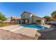 Expansive backyard featuring a sparkling pool and covered patio space, ideal for outdoor living at 6544 E Portia St, Mesa, AZ 85215