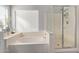 Bathroom features soaking tub and enclosed stand-up shower with glass door at 6544 E Portia St, Mesa, AZ 85215