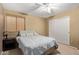 Bedroom featuring a ceiling fan, window, and carpeted floor at 6544 E Portia St, Mesa, AZ 85215