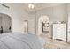 Large bedroom featuring walk-in closet, bathroom access, and neutral color palette at 6544 E Portia St, Mesa, AZ 85215