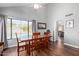 Bright dining room with pool view, hardwood floors, table, and gray wall paint at 6544 E Portia St, Mesa, AZ 85215