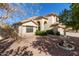 Front exterior of a charming home, featuring a fountain, desert landscaping, and an arched entrance at 6544 E Portia St, Mesa, AZ 85215