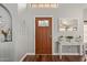 Light-filled foyer featuring wood floors and decorative accents around the front door at 6544 E Portia St, Mesa, AZ 85215
