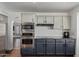 Modern kitchen with stainless steel appliances, two-tone cabinets, granite counters, and hardwood floors at 6544 E Portia St, Mesa, AZ 85215