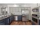 Modern kitchen with stainless steel appliances, two-tone cabinets, granite counters, and hardwood floors at 6544 E Portia St, Mesa, AZ 85215
