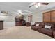Large living room boasts plush seating, desk workspace, and bright, natural light with ceiling fans at 6544 E Portia St, Mesa, AZ 85215