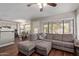 Bright living room with a large sectional sofa, hardwood floors, and view into the kitchen and dining area at 6544 E Portia St, Mesa, AZ 85215