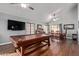 Spacious living room with hardwood floors, a TV, and windows allowing natural light at 6544 E Portia St, Mesa, AZ 85215