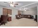 Spacious living room with plush, sectional seating and bright, natural light with ceiling fans at 6544 E Portia St, Mesa, AZ 85215