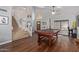 Spacious living room with a billiard table, staircase, hardwood floors, and many windows at 6544 E Portia St, Mesa, AZ 85215