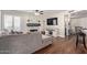 Cozy living room featuring a brick fireplace, hardwood floors, and modern furniture at 6544 E Portia St, Mesa, AZ 85215