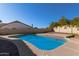 Inviting backyard pool with ample deck space and desert landscaping, perfect for relaxation at 6544 E Portia St, Mesa, AZ 85215