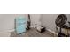 Room featuring retro mini fridge, fan, laminate floors, and utility items at 6544 E Portia St, Mesa, AZ 85215