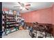 Bonus room featuring red paneling, carpet, and shelves with ample storage for equipment and supplies at 6544 E Portia St, Mesa, AZ 85215