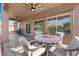 Covered patio featuring a dining table and chairs overlooking the well-maintained backyard at 7346 N 82Nd Ave, Glendale, AZ 85303