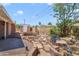 Landscaped backyard with a built-in barbecue, a custom water feature, and a brick patio, perfect for outdoor entertaining at 7526 E Edgemont Ave, Scottsdale, AZ 85257