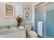 Bright bathroom features blue tiled accents, a framed botanical print, and a glass-enclosed shower at 7526 E Edgemont Ave, Scottsdale, AZ 85257