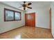 Spacious bedroom with wood floor, window, and a ceiling fan at 7526 E Edgemont Ave, Scottsdale, AZ 85257