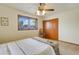 Bedroom with a ceiling fan, window view and a double cushioned bench by the foot of the bed at 7526 E Edgemont Ave, Scottsdale, AZ 85257